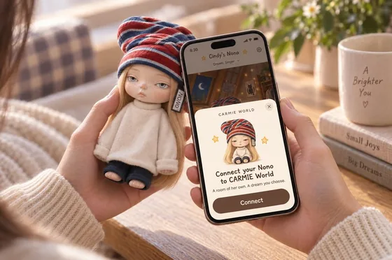 Two hands holding a Nono doll next to a phone that says: Connect your Nono to CARMIE World